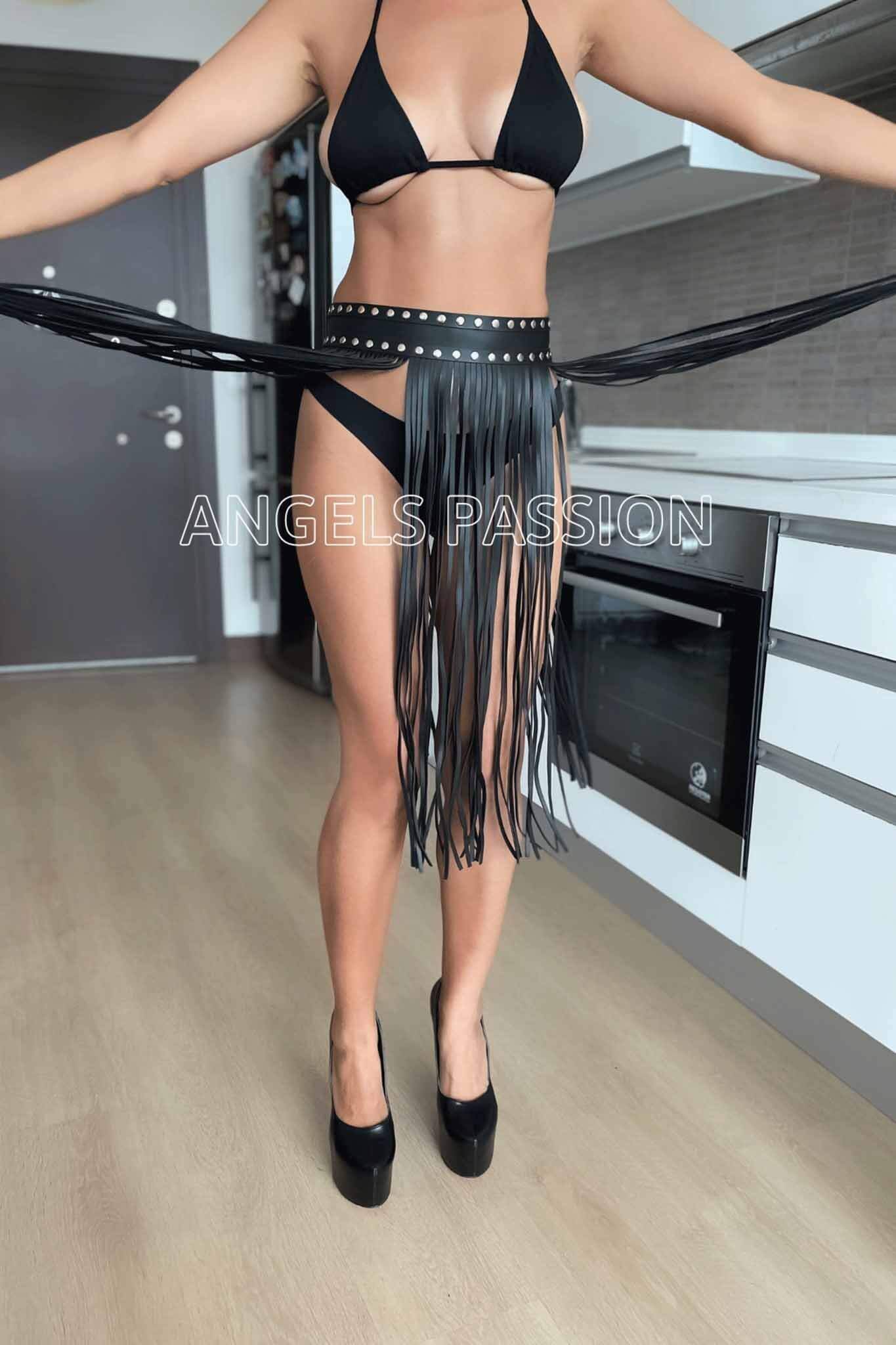 A stylish tassel fringe maxi skirt belt made of faux leather, featuring a hook and eye closure and available in black and red colors.