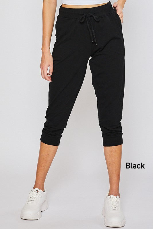 Terry Boyfriend Oversized Capri Jogger Pants in various colors, showcasing the relaxed fit and drawstring waist.