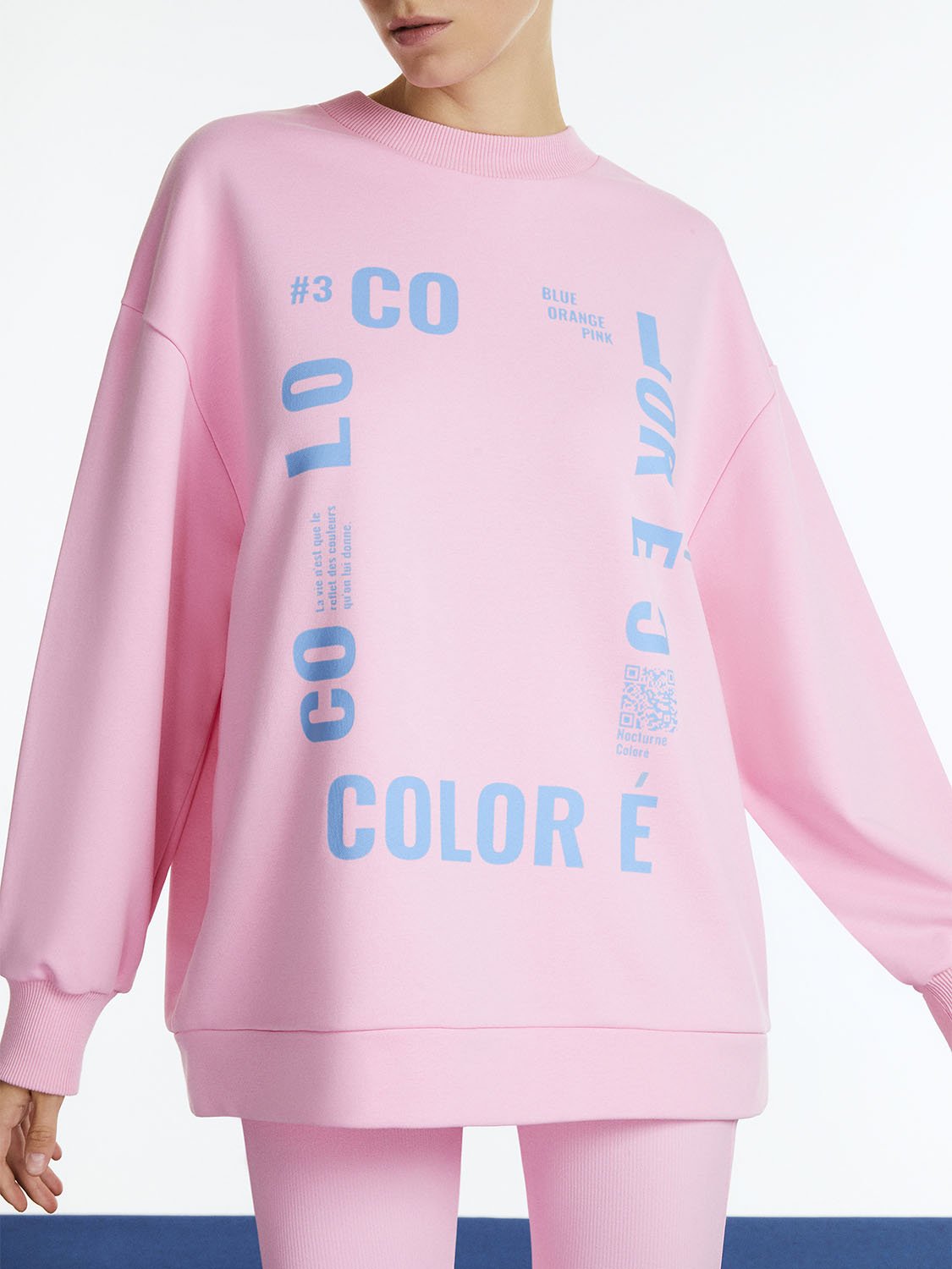 Text Oversized Sweatshirt featuring a wide crew neck, dropped shoulders, and vibrant colors of orange, pink, and blue with front text print.