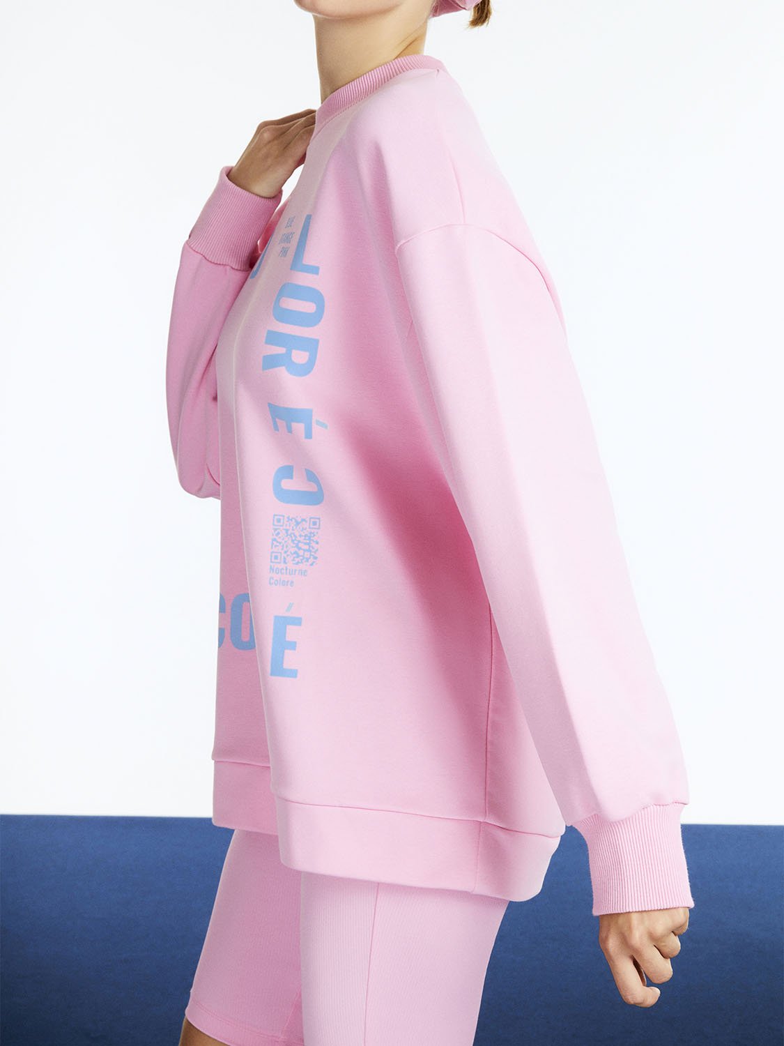 Text Oversized Sweatshirt featuring a wide crew neck, dropped shoulders, and vibrant colors of orange, pink, and blue with front text print.