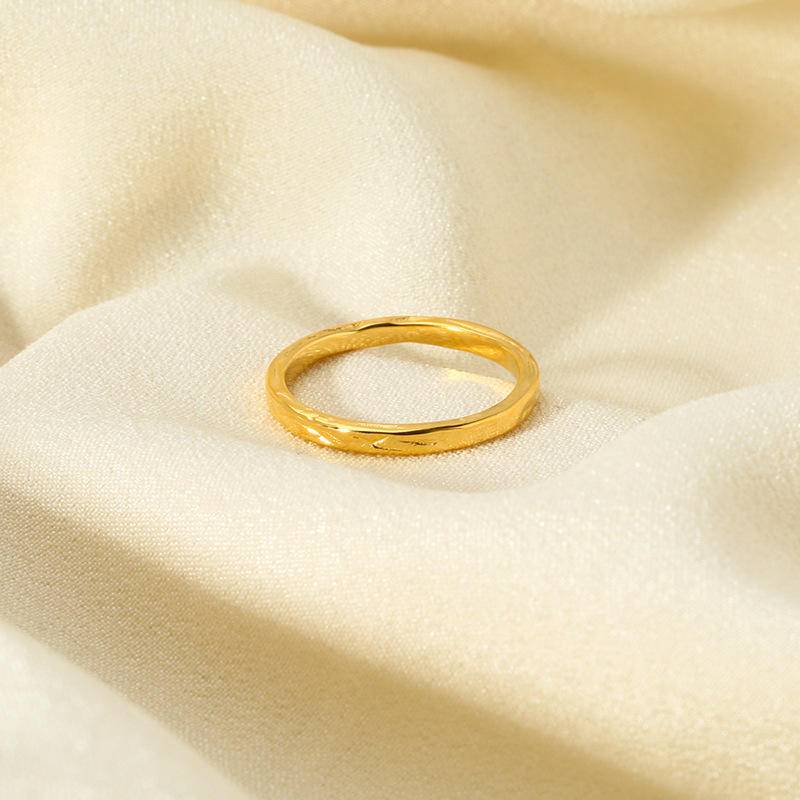 A beautifully crafted 18K gold plated ring with a textured geometric design, displayed in an elegant gift box.