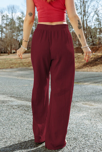 A pair of stylish Texture Tied Wide Leg Pants in a soft cotton fabric, featuring a tied waist design and a wide-leg silhouette.