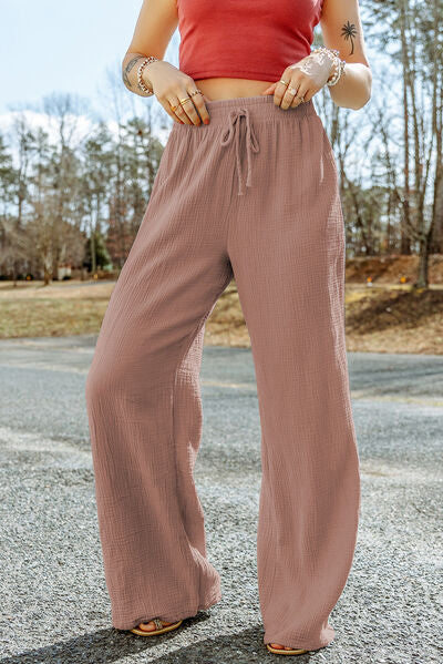 A pair of stylish Texture Tied Wide Leg Pants in a soft cotton fabric, featuring a tied waist design and a wide-leg silhouette.