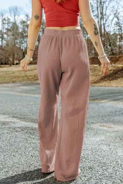 A pair of stylish Texture Tied Wide Leg Pants in a soft cotton fabric, featuring a tied waist design and a wide-leg silhouette.