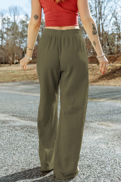 A pair of stylish Texture Tied Wide Leg Pants in a soft cotton fabric, featuring a tied waist design and a wide-leg silhouette.