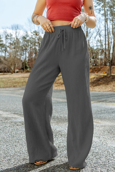 A pair of stylish Texture Tied Wide Leg Pants in a soft cotton fabric, featuring a tied waist design and a wide-leg silhouette.