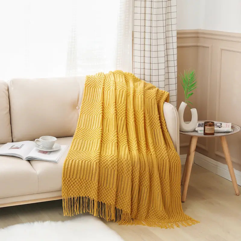 A soft, textured knit throw blanket in a cozy setting, perfect for snuggling.