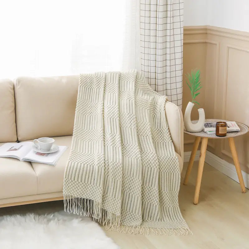 A soft, textured knit throw blanket in a cozy setting, perfect for snuggling.