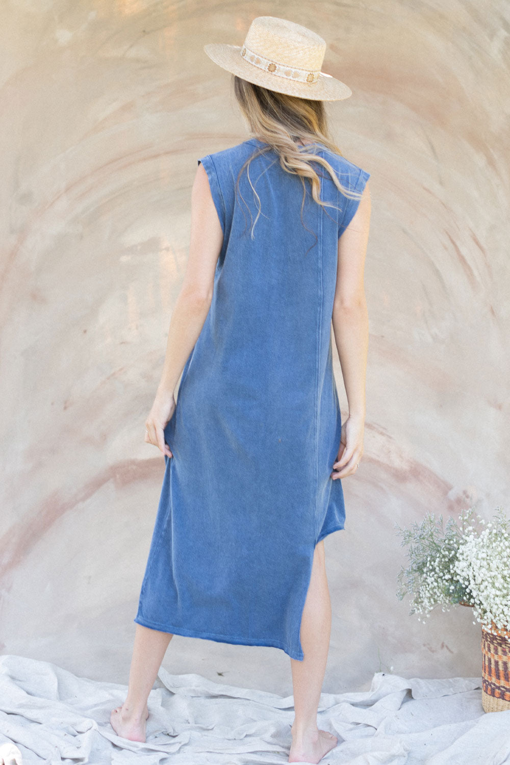 The Amber Dress featuring an asymmetrical design in Denim color, showcasing its stylish silhouette and comfortable fabric.