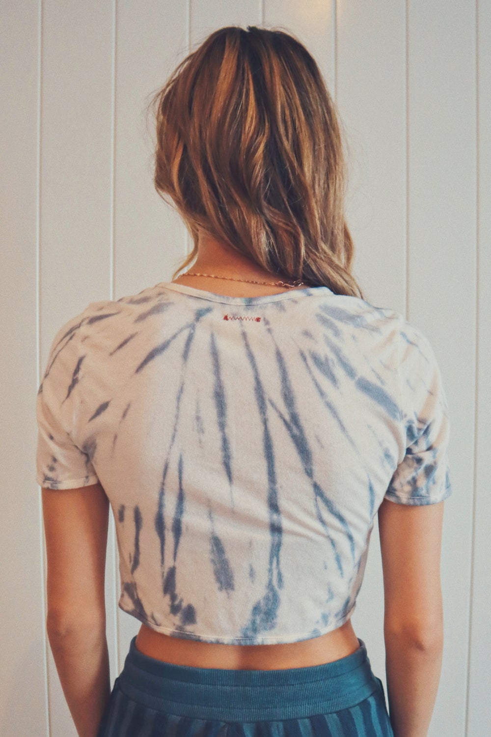 The Ana Tie-Dye crop top featuring a unique black and white tie-dye pattern, made from hemp and organic cotton, displayed on a model.