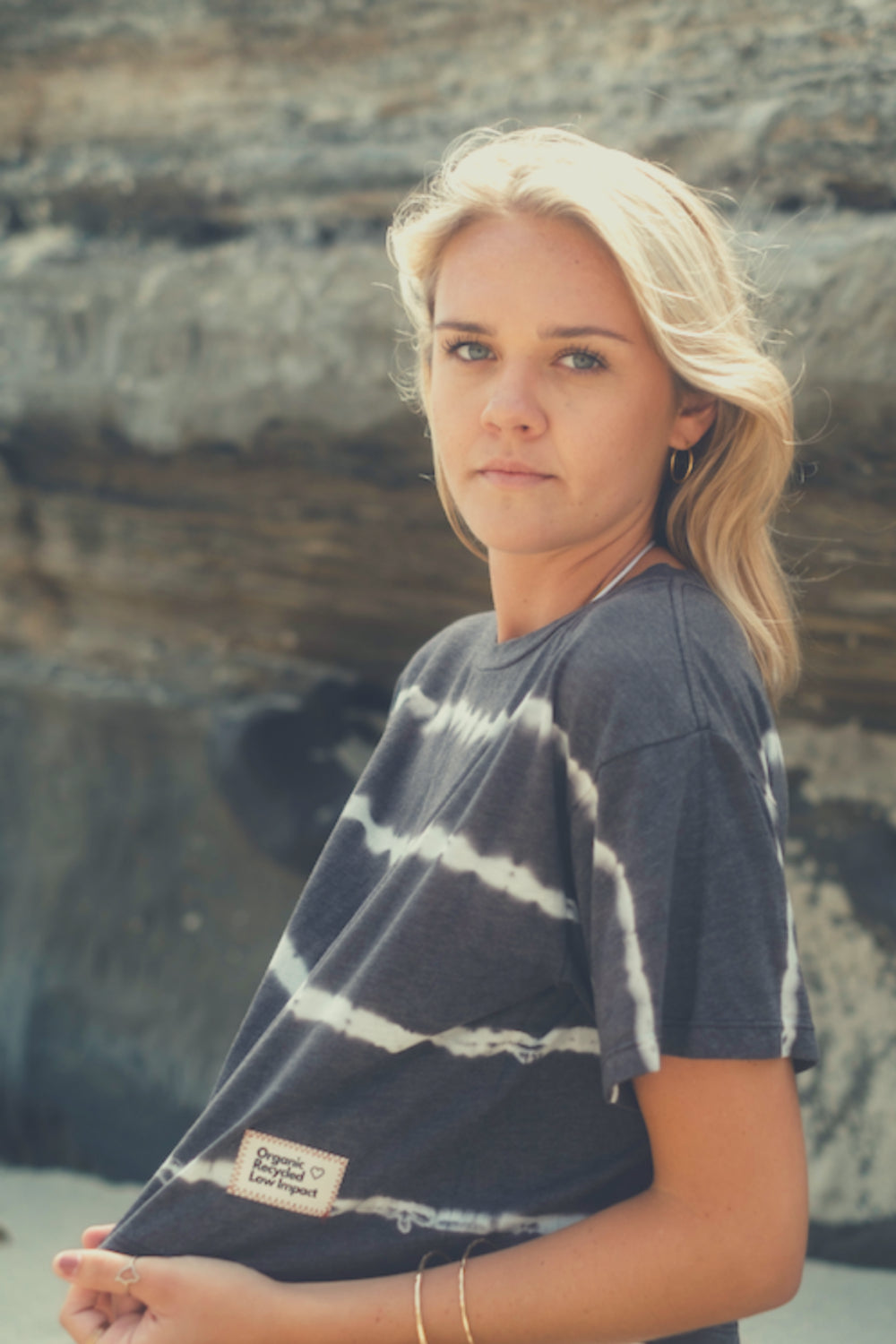 The Awaken Boxy Cropped T-Shirt in a vibrant tie-dye pattern, showcasing its lightweight fabric and relaxed fit, perfect for summer wear.