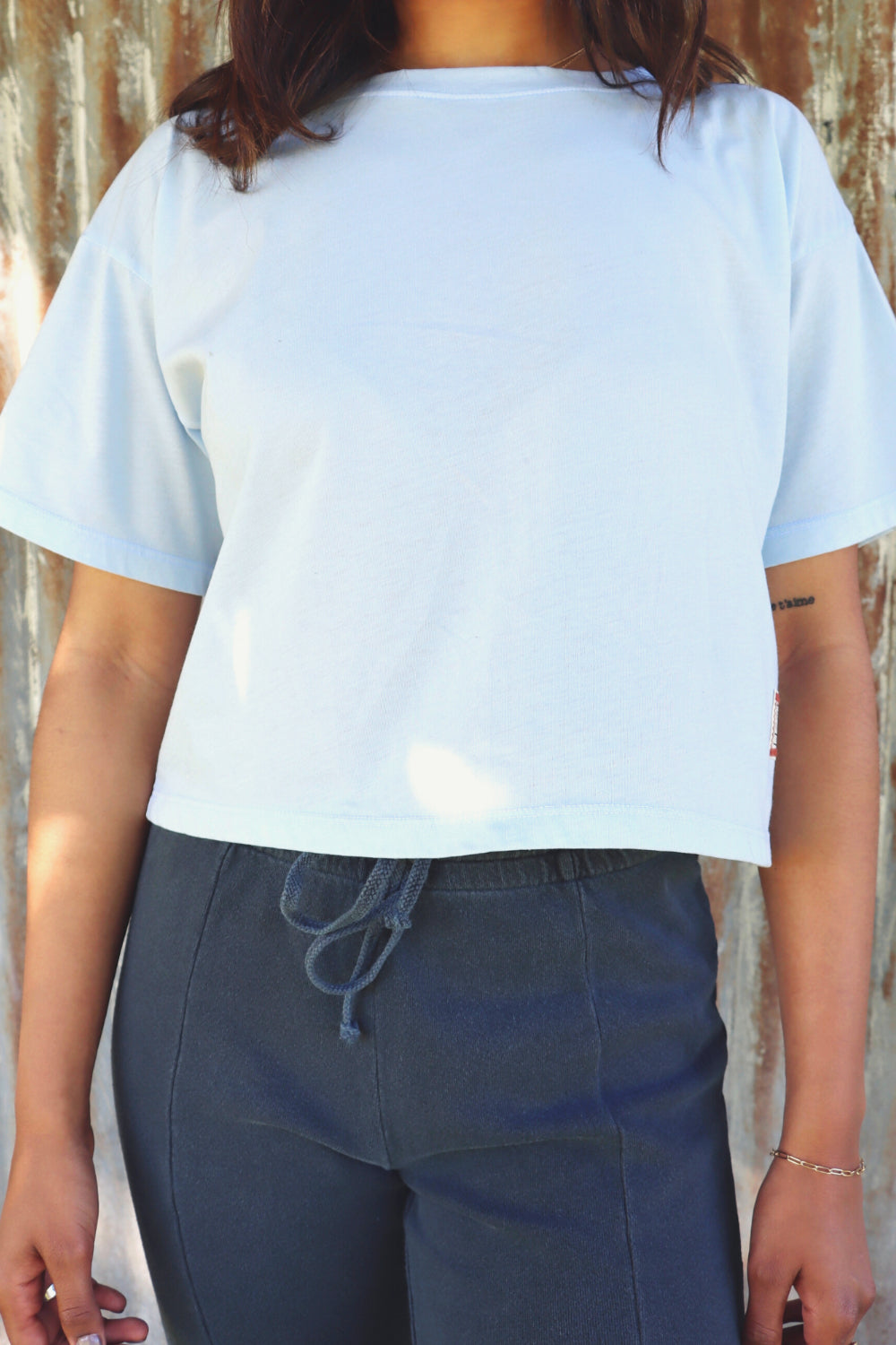 A lightweight boxy cropped t-shirt in Sky Blue and Apricot, showcasing its relaxed fit and eco-friendly fabric.