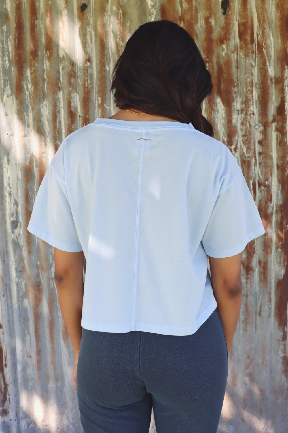 A lightweight boxy cropped t-shirt in Sky Blue and Apricot, showcasing its relaxed fit and eco-friendly fabric.