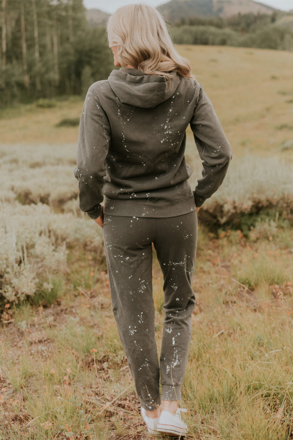 A pair of charcoal joggers with paint splatter design, featuring slant pockets and elastic hem, made from 100% organic cotton.