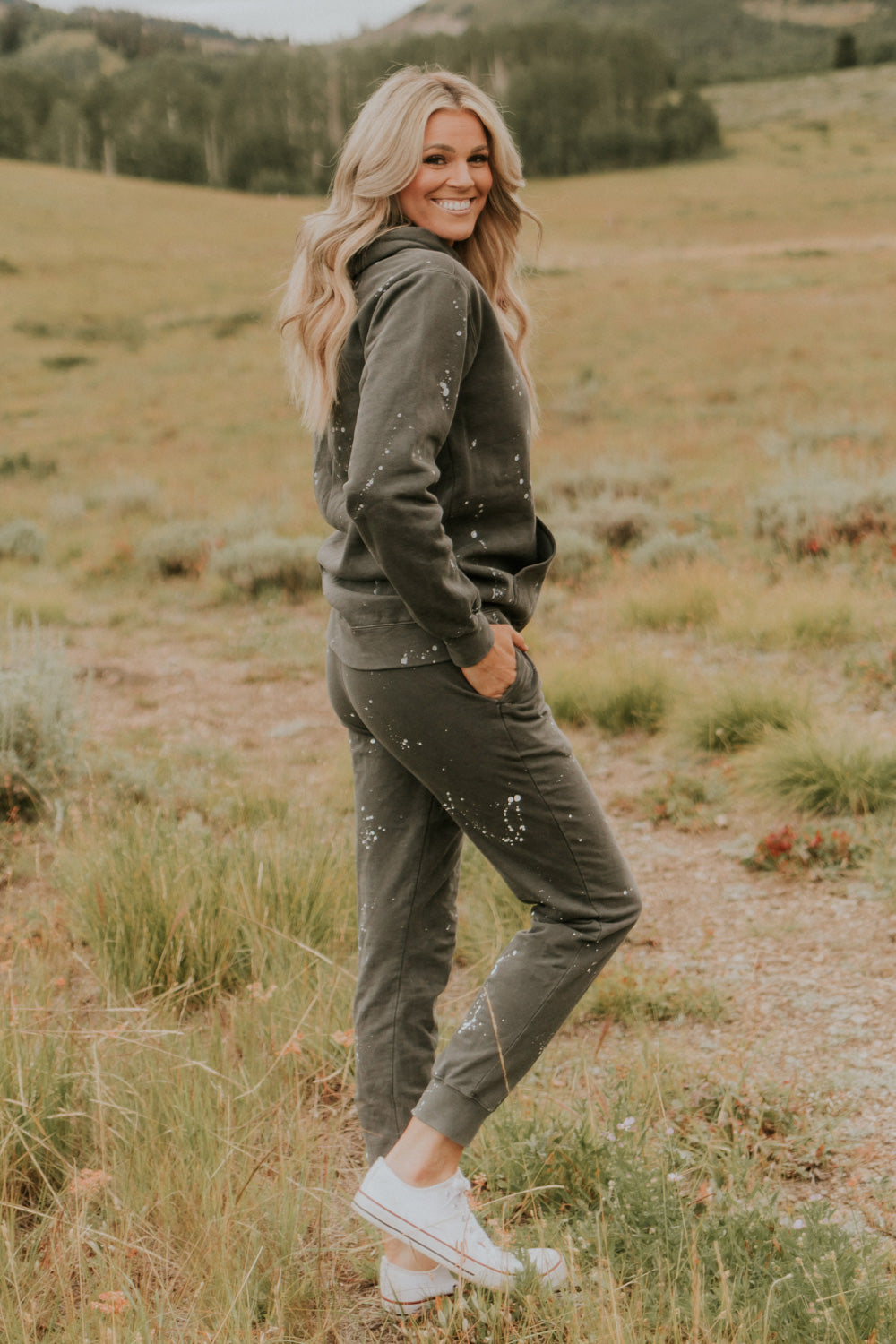 A pair of charcoal joggers with paint splatter design, featuring slant pockets and elastic hem, made from 100% organic cotton.