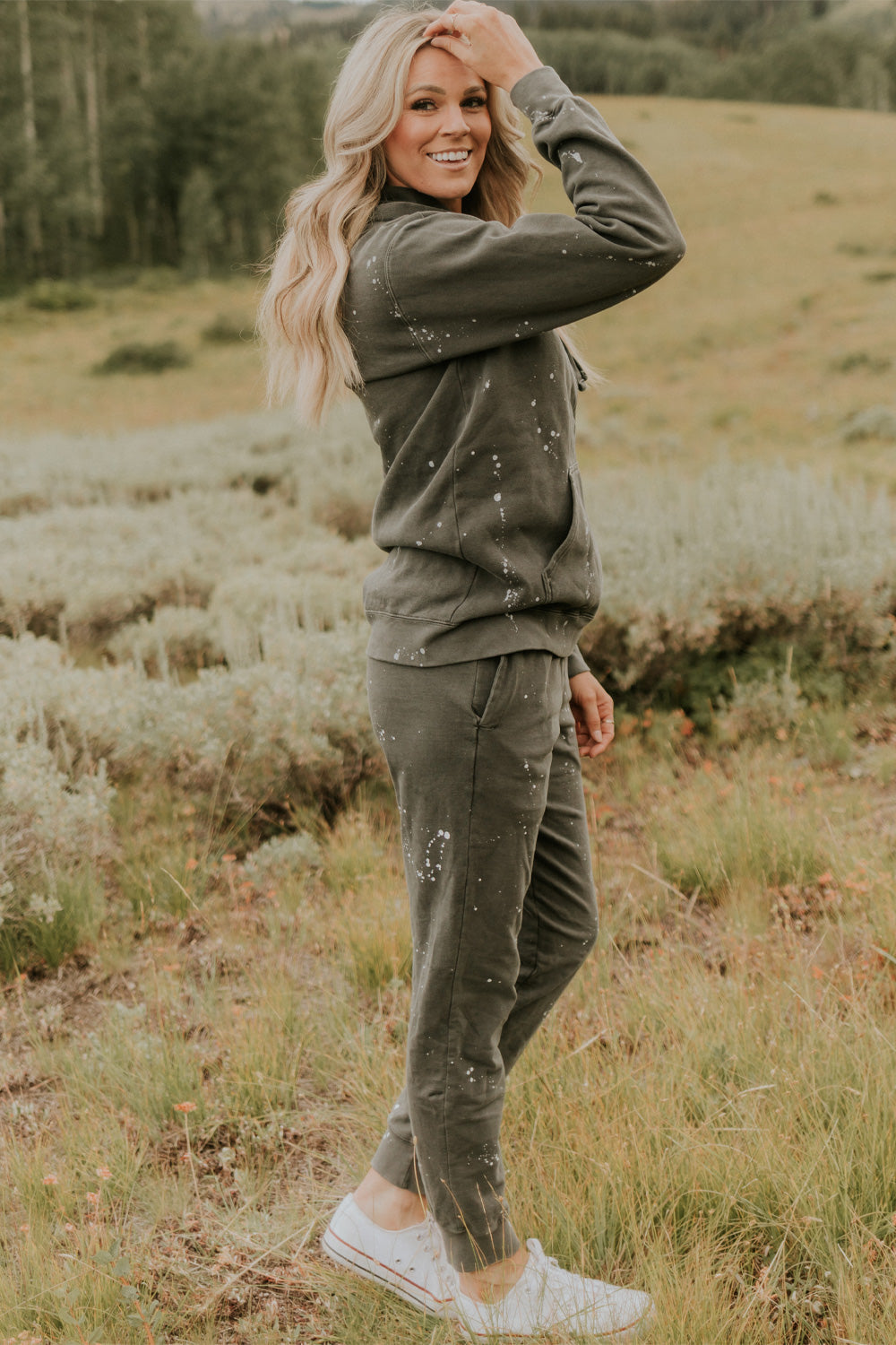 A pair of charcoal joggers with paint splatter design, featuring slant pockets and elastic hem, made from 100% organic cotton.