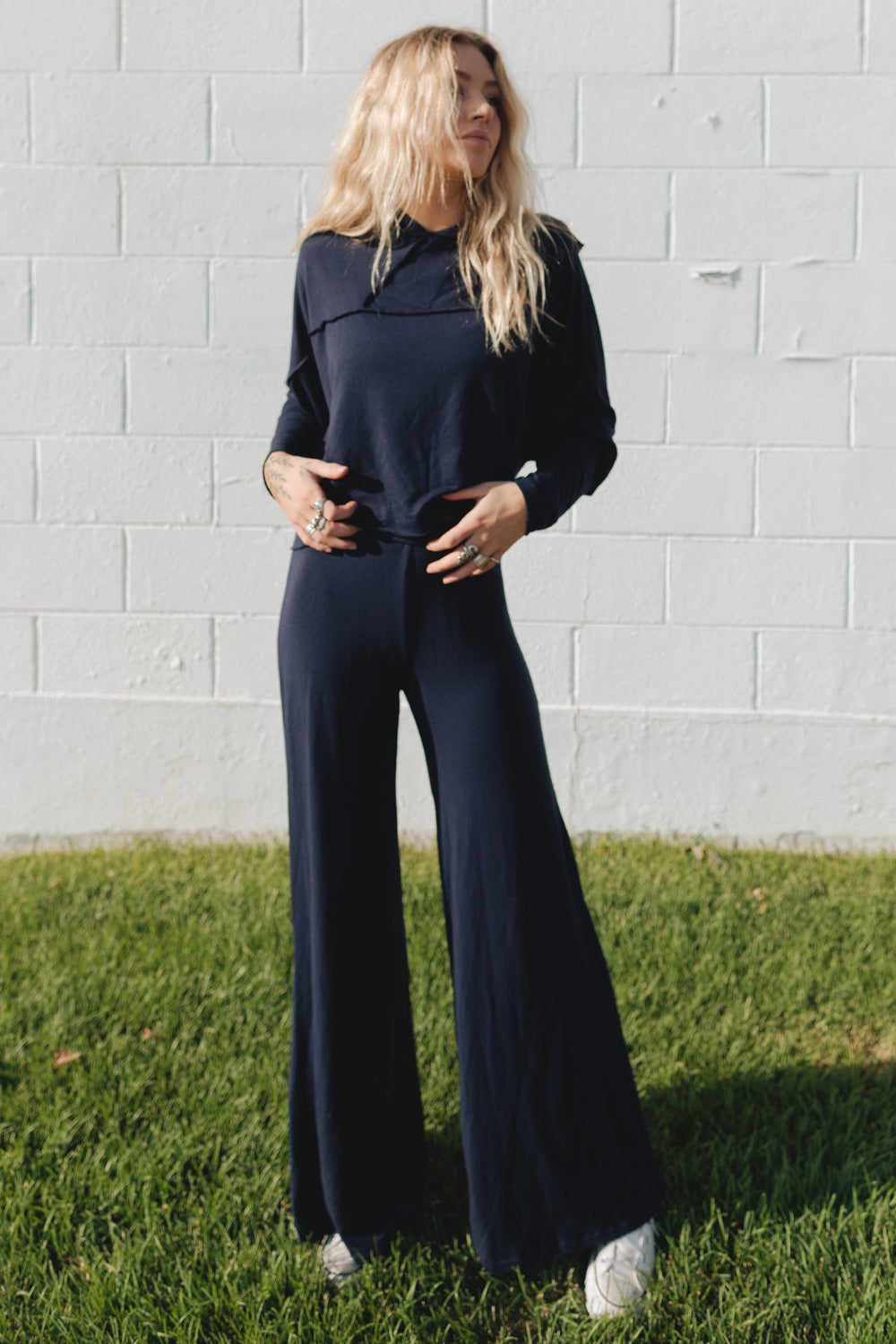 The Bell pants in navy and heather gray, featuring a perfect flare and elastic waist, displayed on a model.