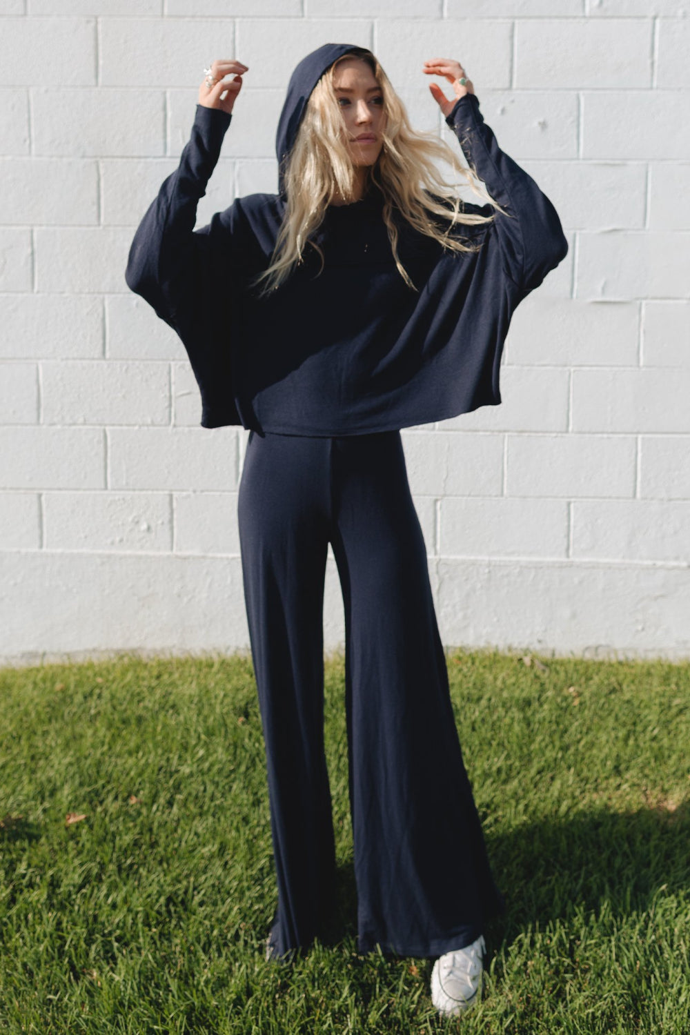 The Bell pants in navy and heather gray, featuring a perfect flare and elastic waist, displayed on a model.