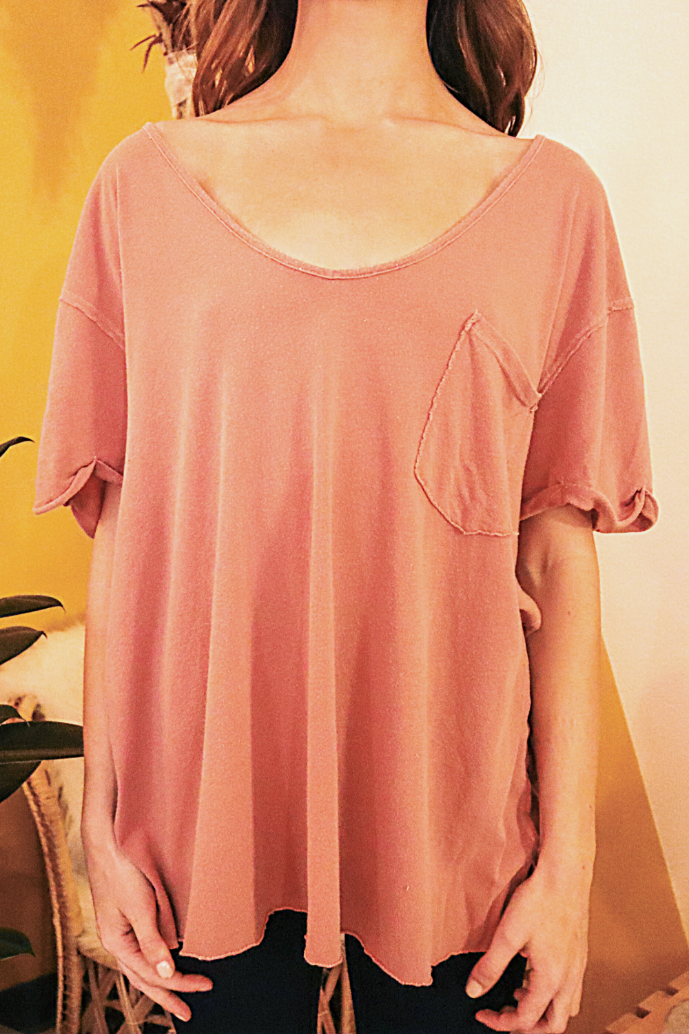 The Carli oversized slouchy tee in pink, featuring a pocket, rolled sleeves, and a back seam detail.