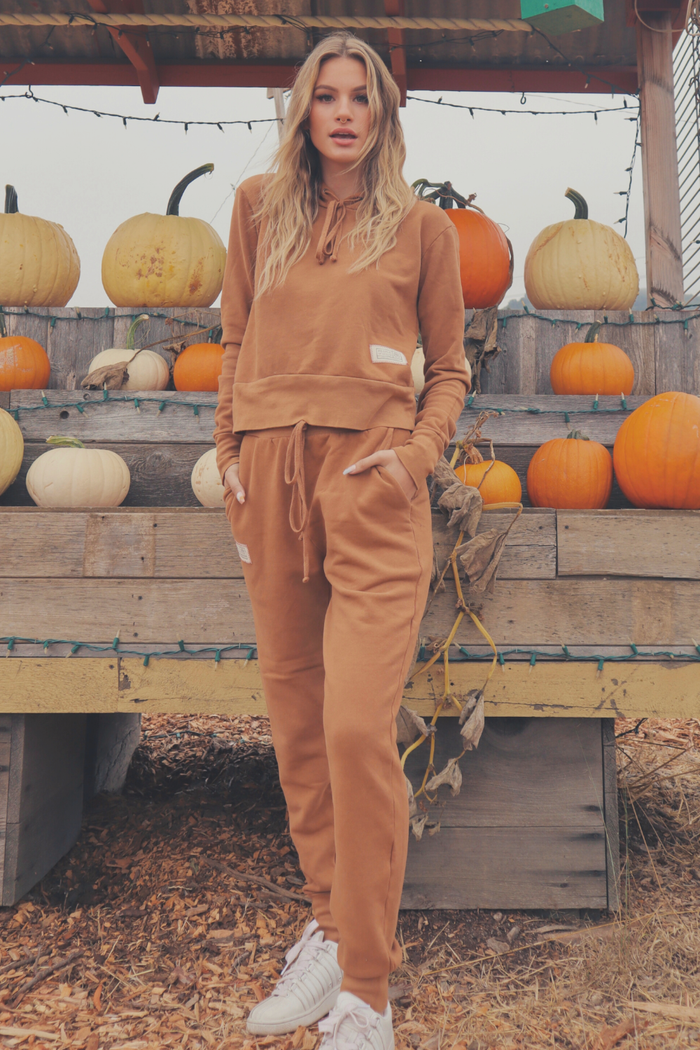 A pair of high-waisted Daybreak Joggers made from 100% organic cotton, featuring elastic ankle details and pockets, displayed in a stylish setting.