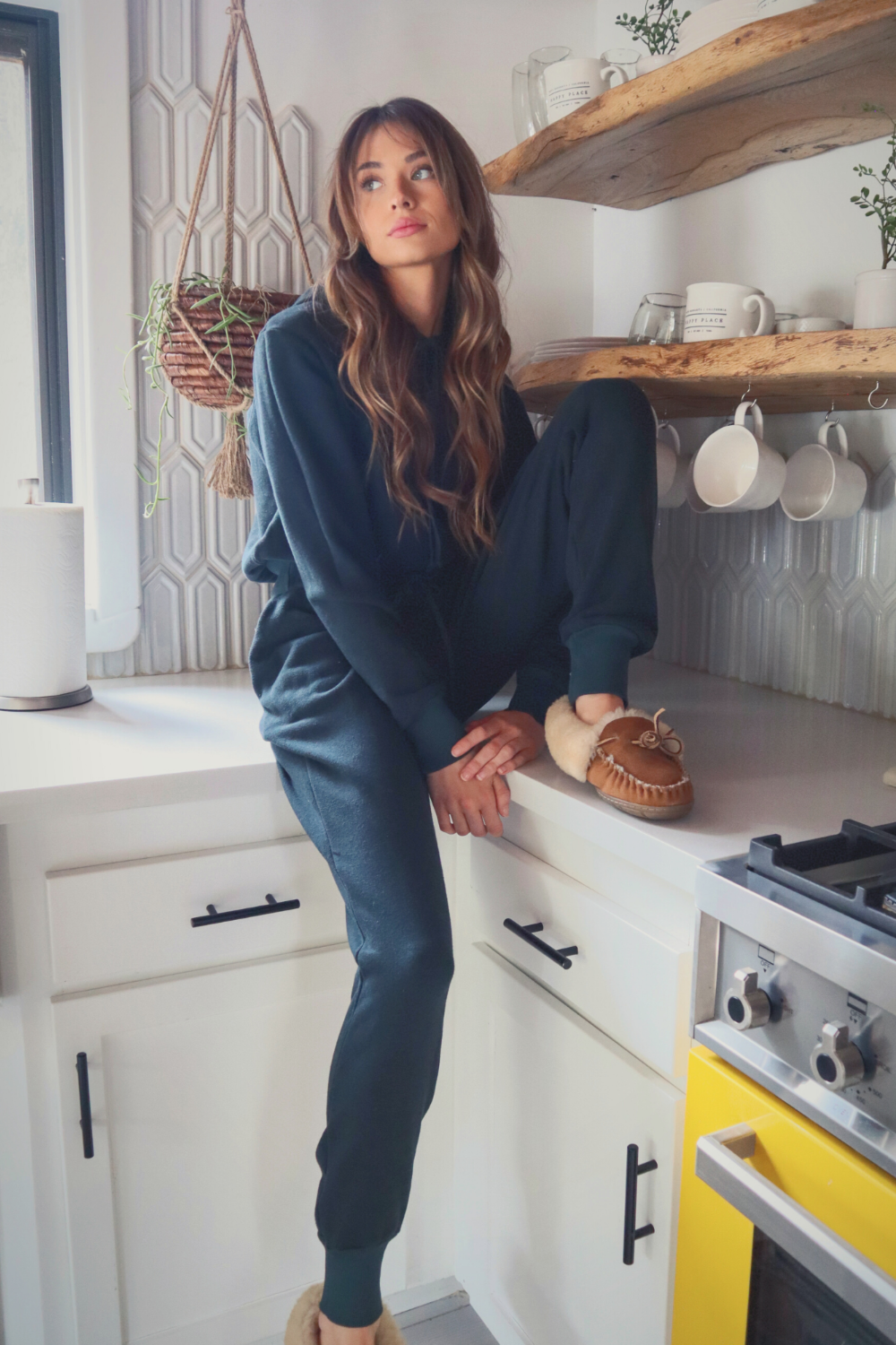 A pair of high-waisted Daybreak Joggers made from 100% organic cotton, featuring elastic ankle details and pockets, displayed in a stylish setting.