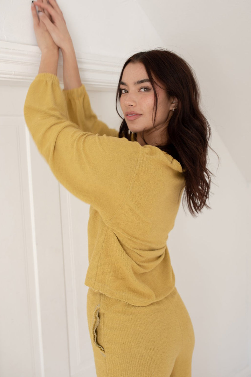 The Desert Pullover in various colors including Navy, Persimmon, Honey, and Oatmeal, showcasing its crew neck and drop shoulder design.