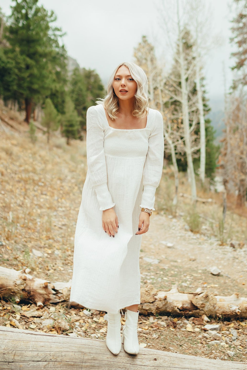 The Eleanor Dress featuring long sleeves, square neckline, and straight skirt in white organic cotton.