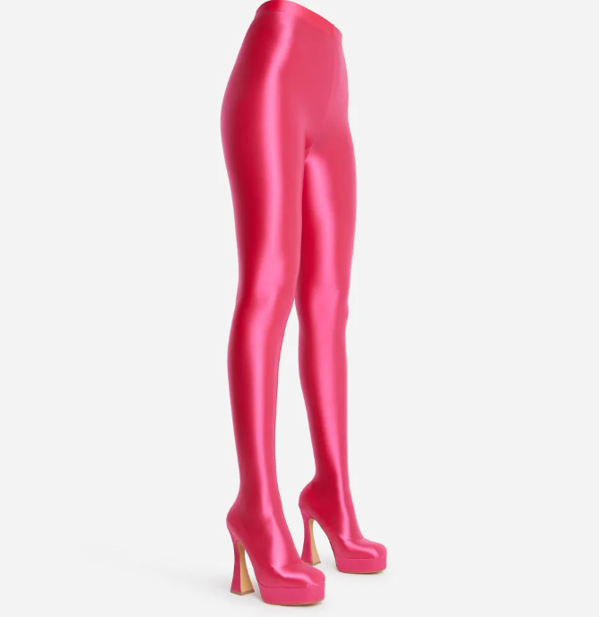 The Giselle Boot in pink lycra with a platform sole and flared block heel, showcasing its stylish long legging design.