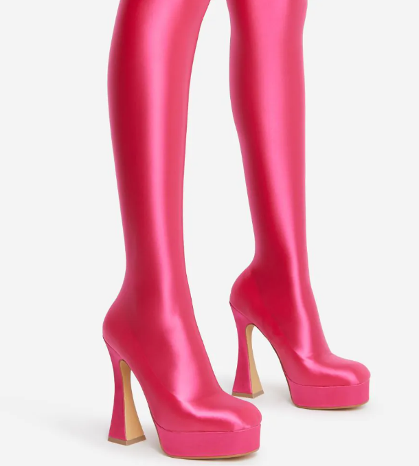 The Giselle Boot in pink lycra with a platform sole and flared block heel, showcasing its stylish long legging design.