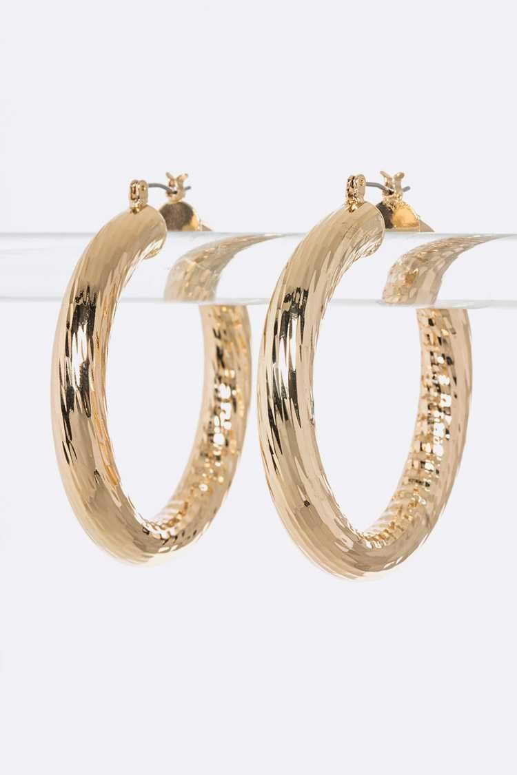 A pair of elegant Goddess Loop Earrings featuring a 2-inch drop, crafted from lead and nickel compliant materials, perfect for sensitive ears.