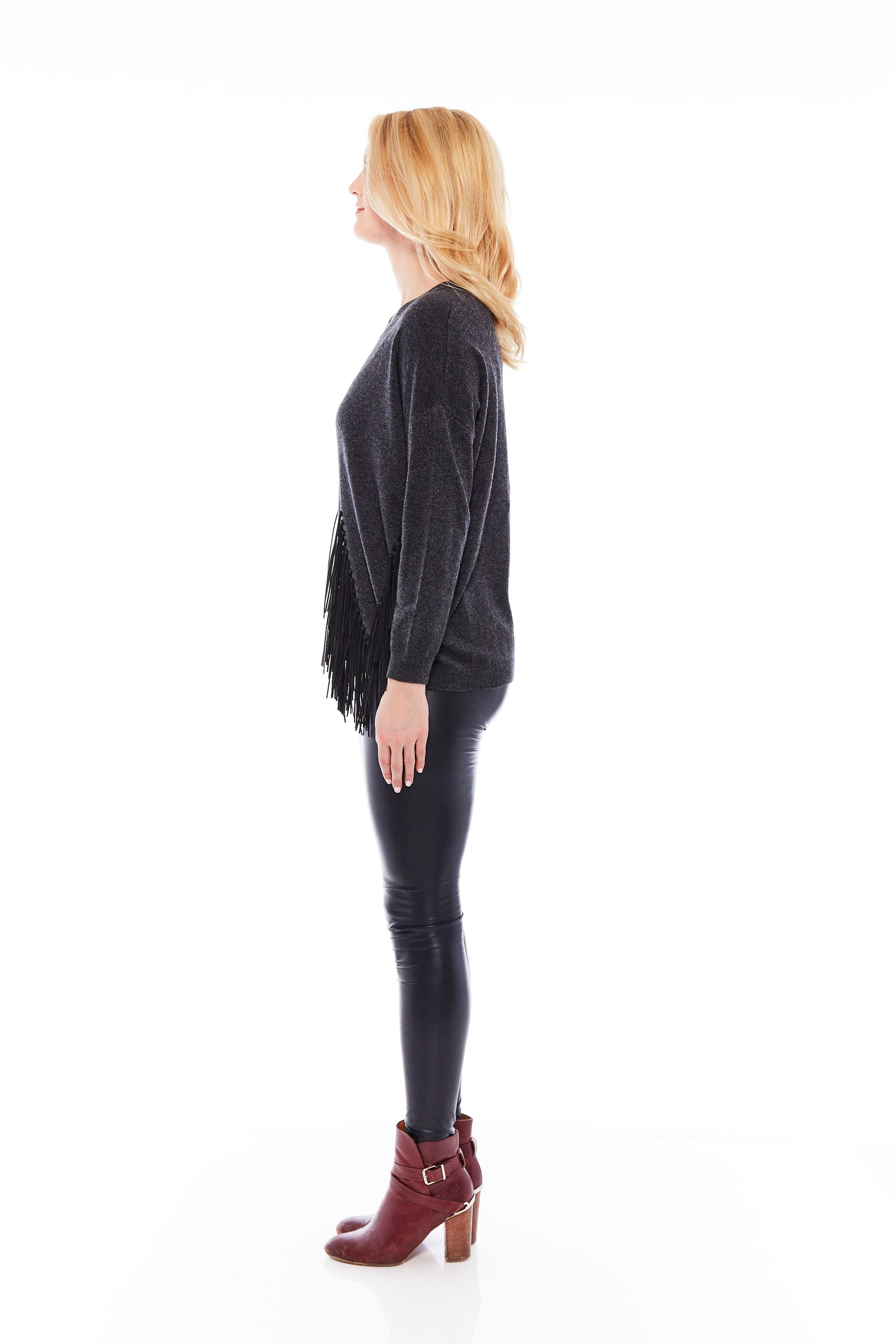 A stylish charcoal black sweater featuring leather tassels, showcasing a soft brushed fabric and a round neck design, perfect for casual and office wear.