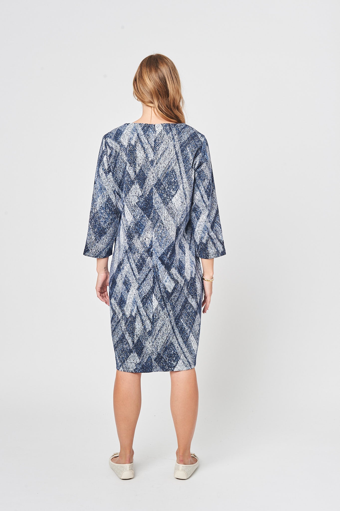 A cozy oversized dress in whitish blue with 3/4 sleeves and a double layer crew neck, perfect for casual wear.