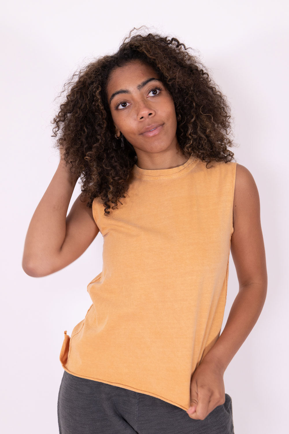 The Margo Tank, a vintage-inspired organic cotton tank top with exaggerated seams and distressed hems, showcasing a relaxed fit.