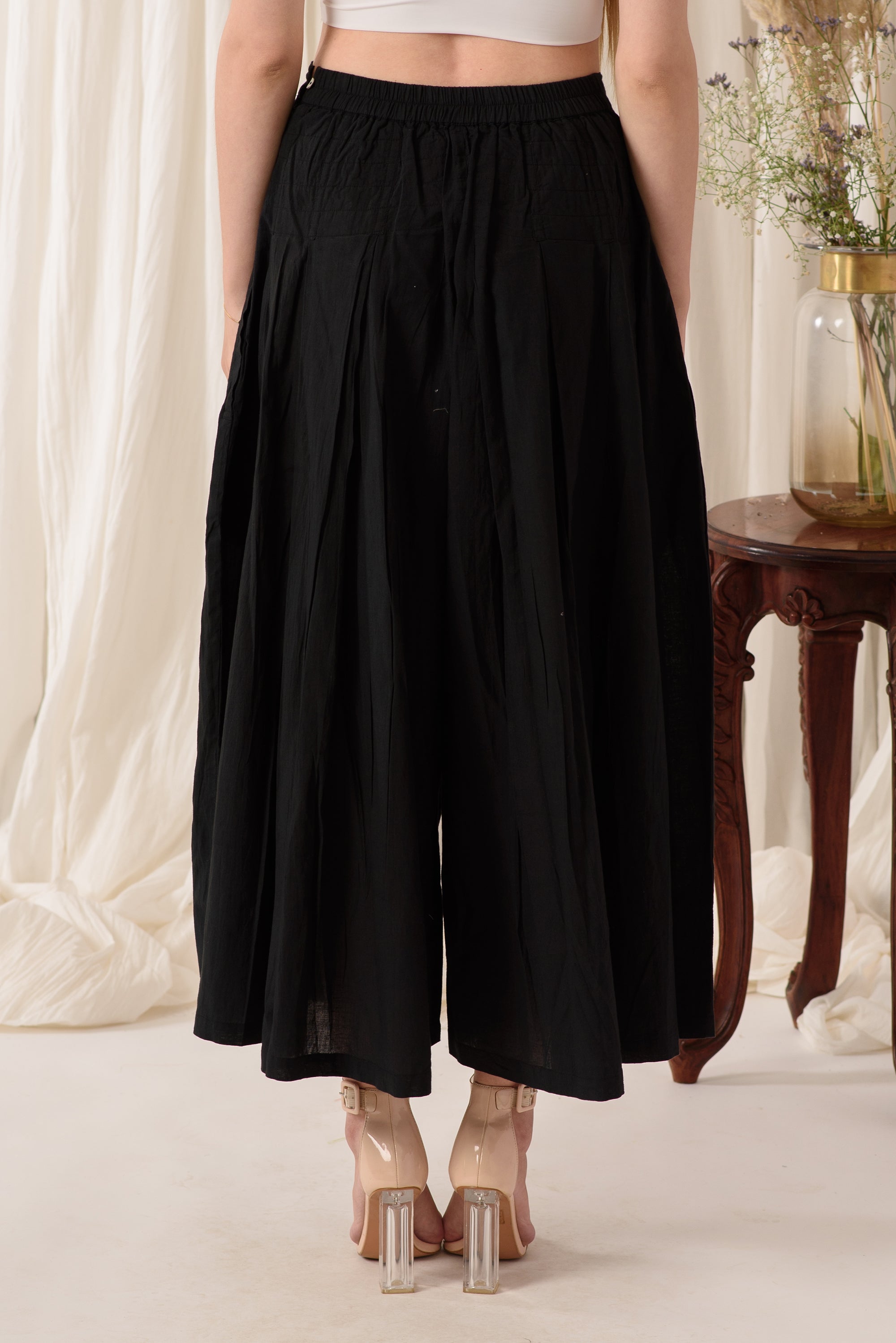 Stylish high-waisted flared pants in midnight black, showcasing a soft fabric and flattering silhouette.