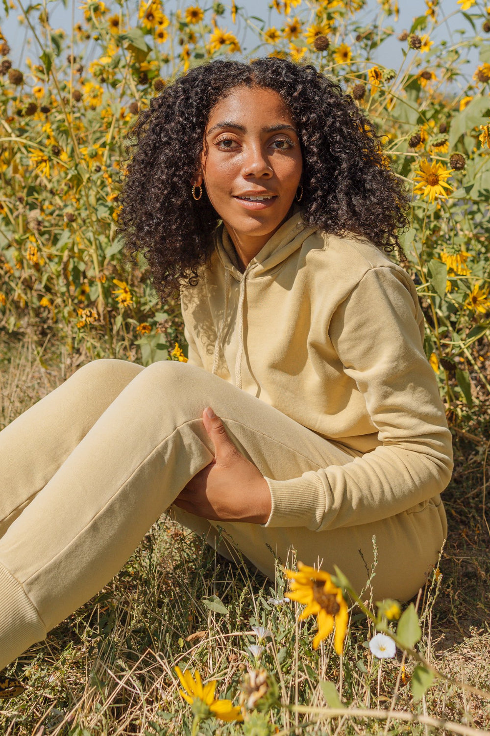 The New Daybreak Hoodie 2.0 in Apricot color, showcasing its relaxed fit and cropped design, perfect for casual wear.