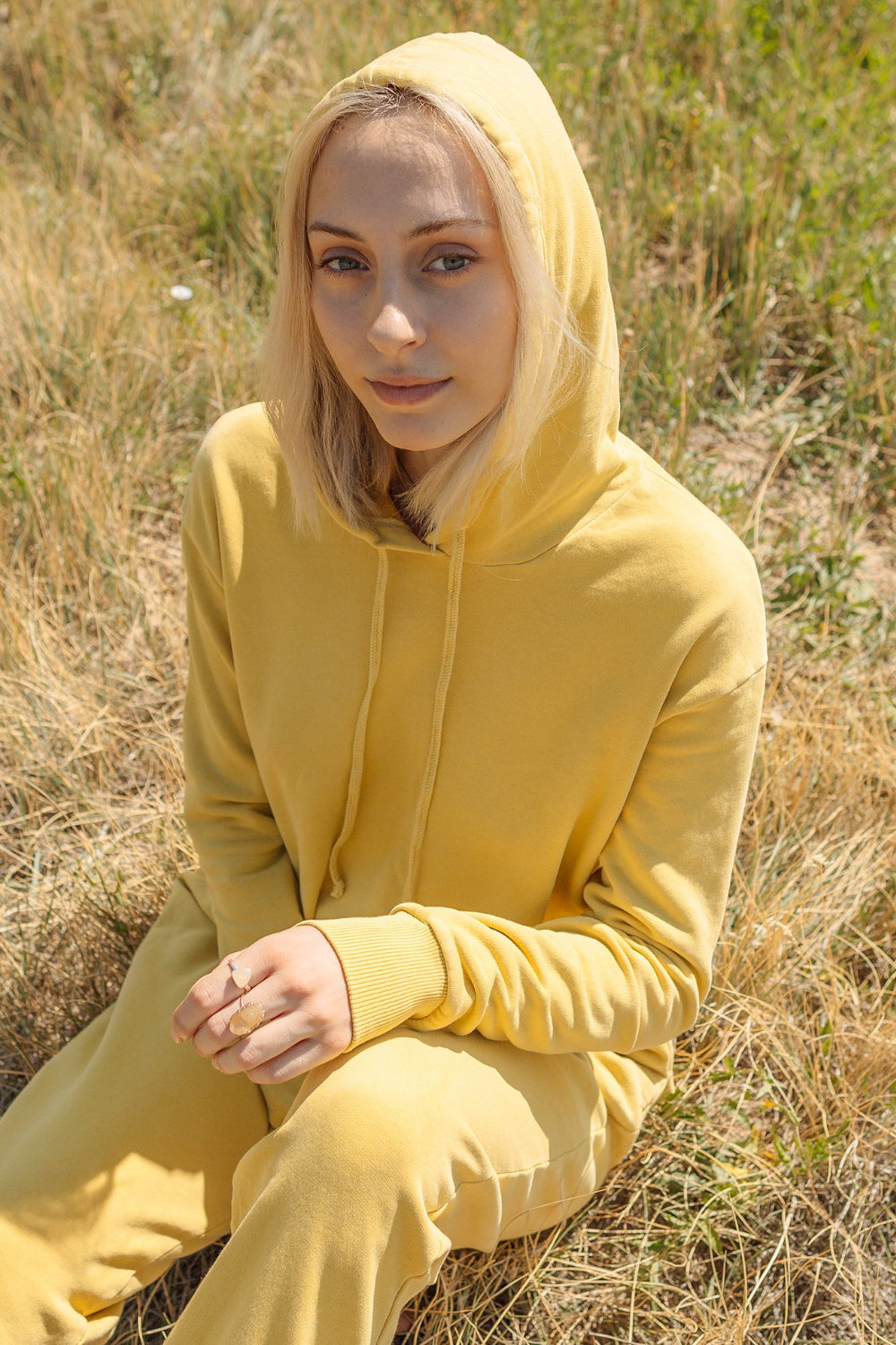 The New Daybreak Hoodie 2.0 in Apricot color, showcasing its relaxed fit and cropped design, perfect for casual wear.