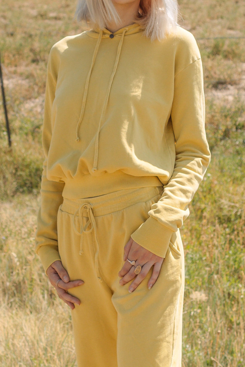 The New Daybreak Hoodie 2.0 in Apricot color, showcasing its relaxed fit and cropped design, perfect for casual wear.