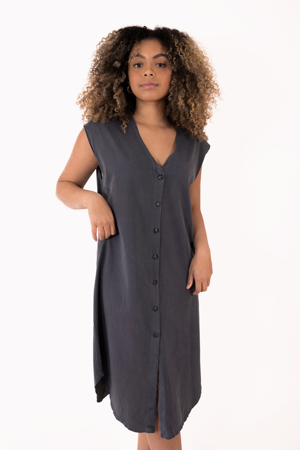 The New Grace Dress displayed on a mannequin, featuring a button-up design and flowing midi length in Navy color.