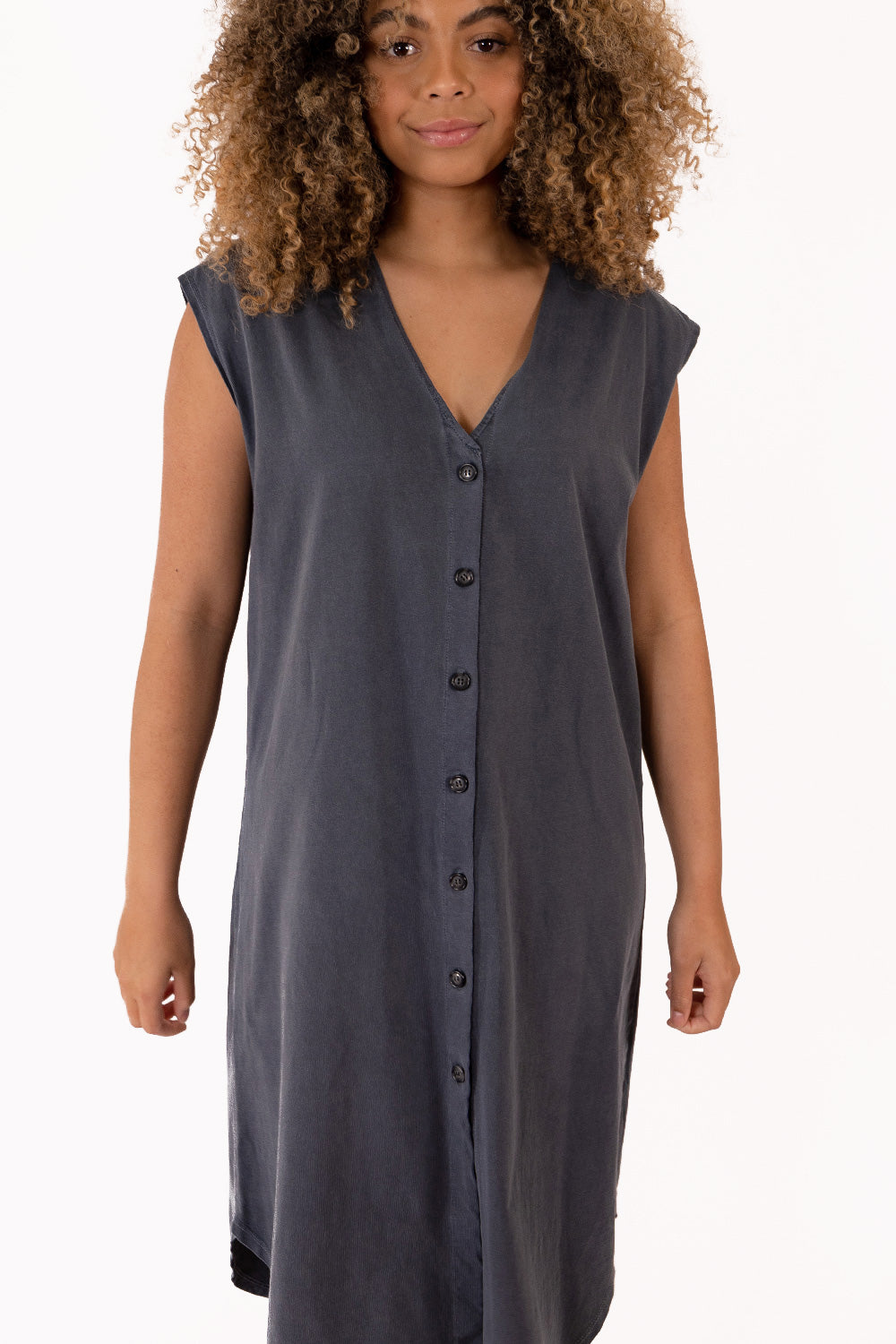 The New Grace Dress displayed on a mannequin, featuring a button-up design and flowing midi length in Navy color.