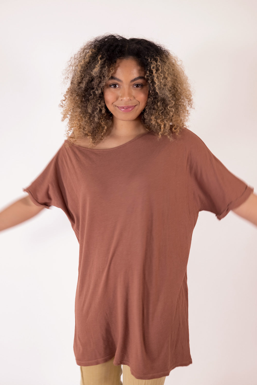 The Rocker Tee in an oversized slouchy silhouette, made from organic cotton and hemp, available in brown, black, and saddle colors.