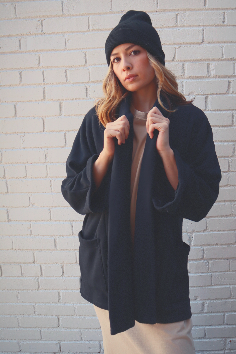 The Rumi layering piece in Washed Black, showcasing its soft fabric and relaxed fit, perfect for summer or cozy wear.