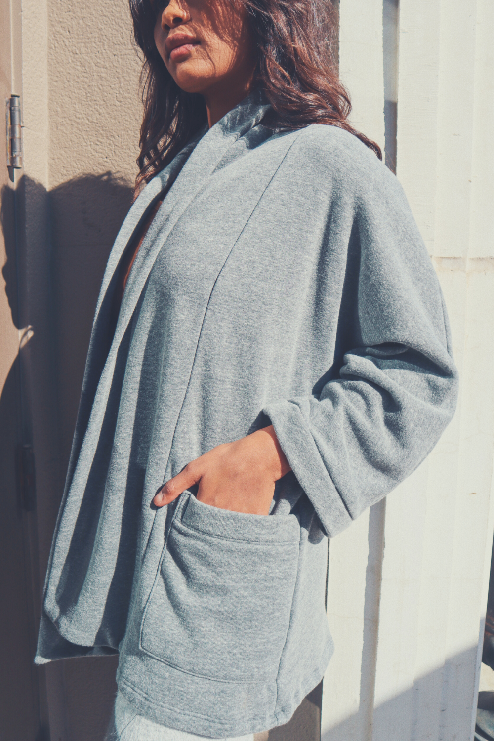 The Rumi layering piece in Washed Black, showcasing its soft fabric and relaxed fit, perfect for summer or cozy wear.