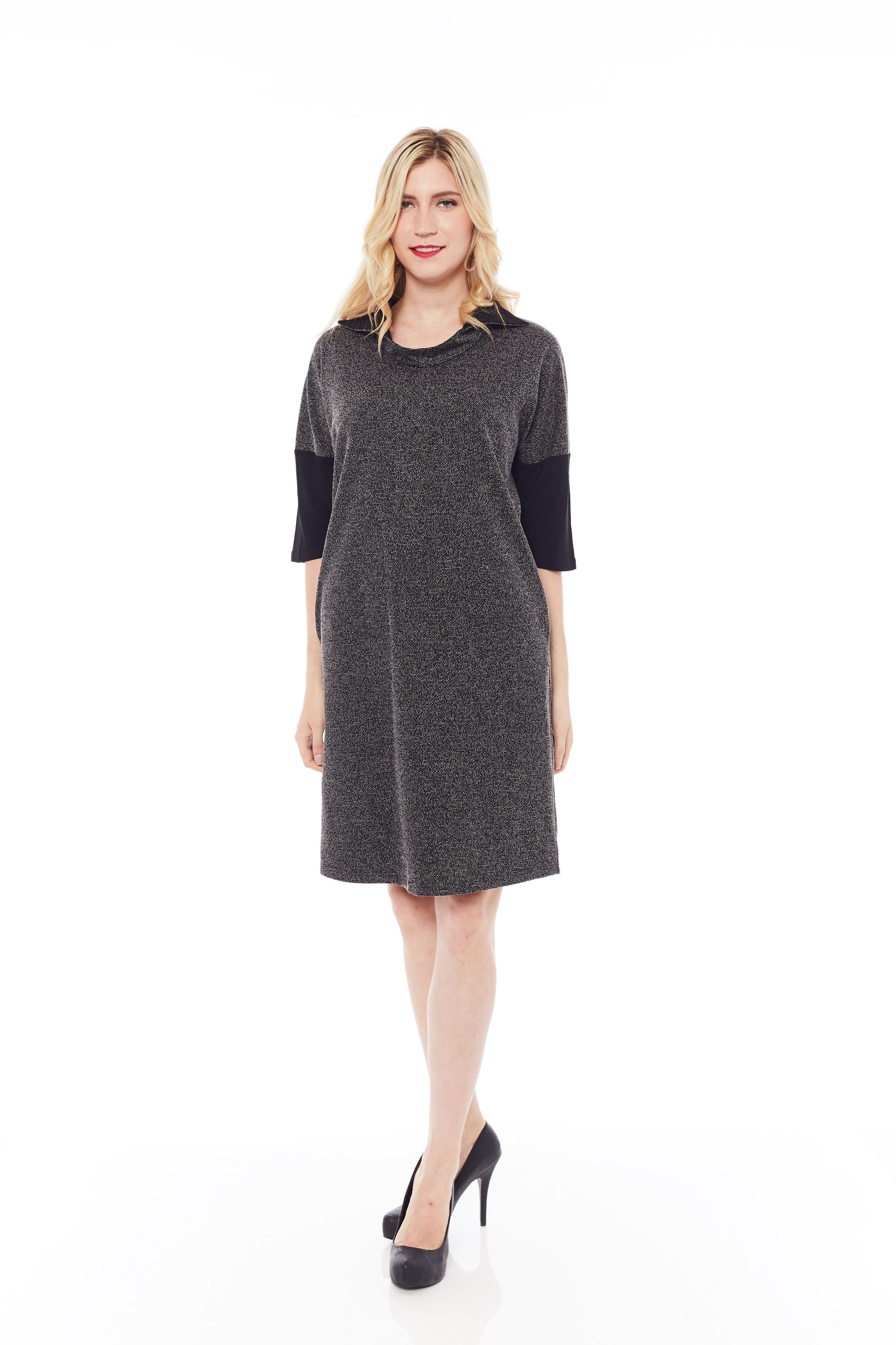 A stylish woman wearing the Shimmery Dress in Classic Black, showcasing its soft fabric and elegant design.