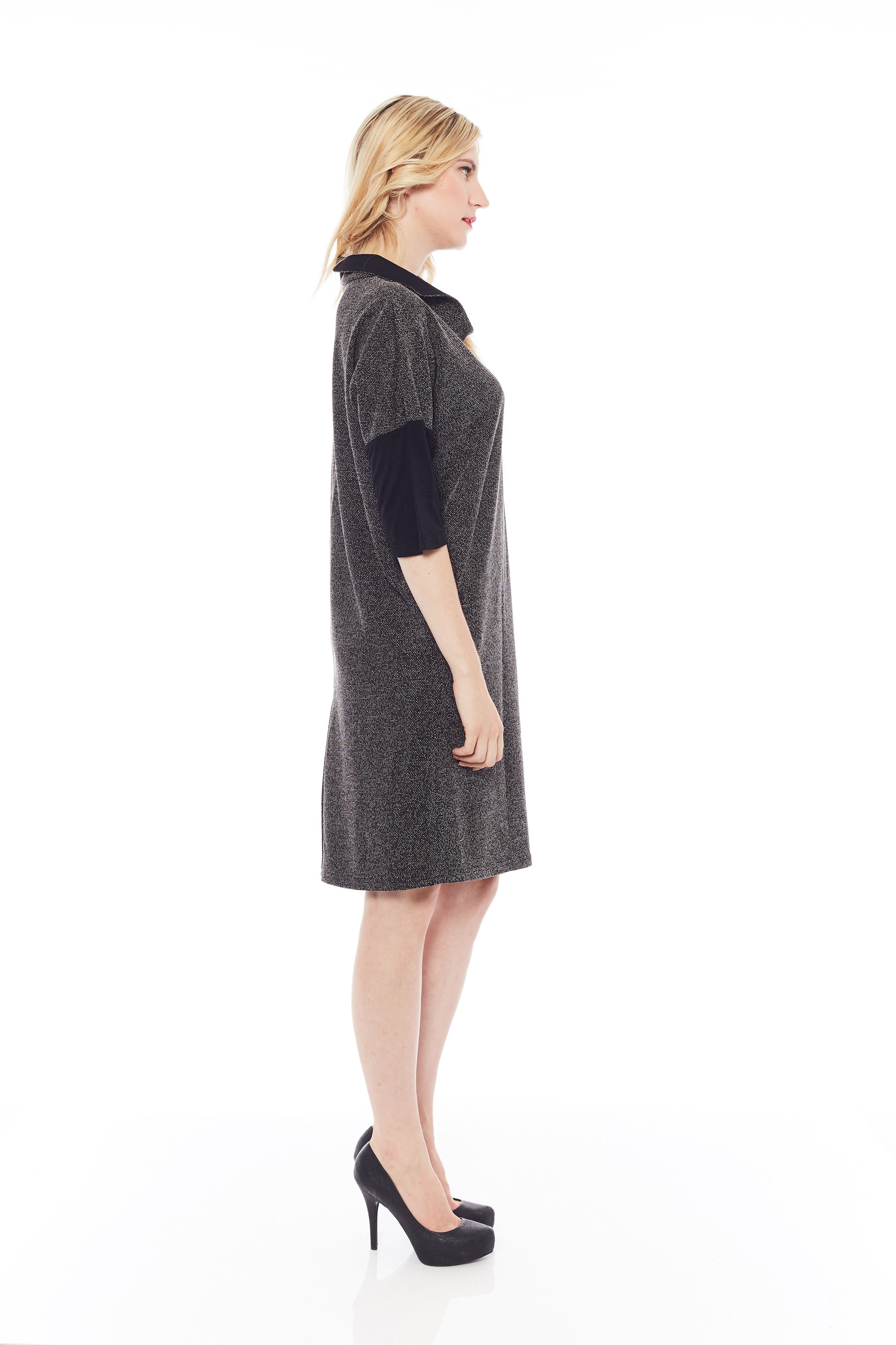 A stylish woman wearing the Shimmery Dress in Classic Black, showcasing its soft fabric and elegant design.