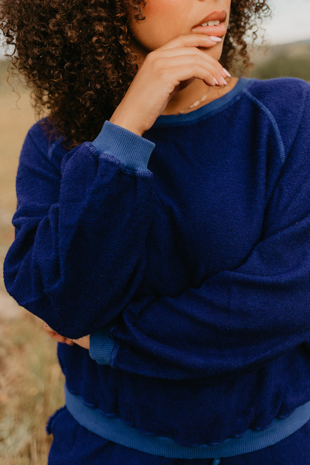 The Smile Sweatshirt in an oversized fit, featuring a feminine neckline and ribbed hems, made from 100% organic cotton.