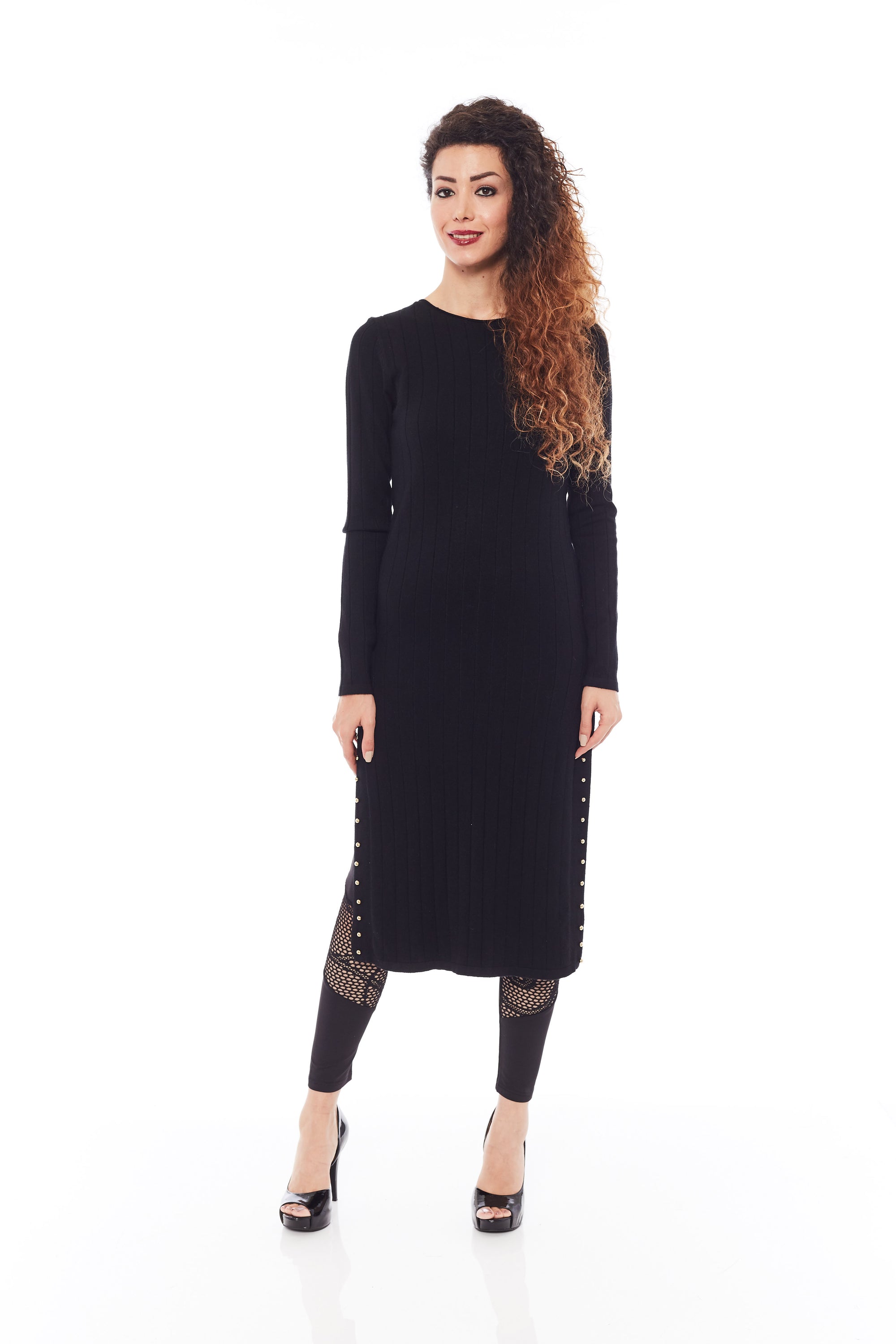 A stylish black sweater with long sleeves and side splits, showcasing its soft fabric and modern design.