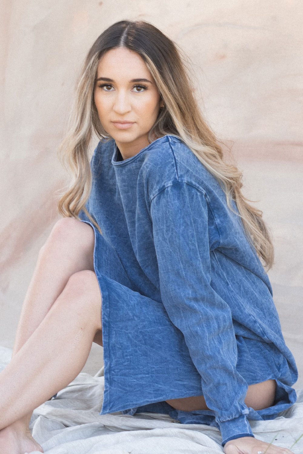 The Taylor Dress in four colors: Brown, Denim, Washed Black, and Peach, featuring long sleeves, a crew neck, and a slight hem slit.