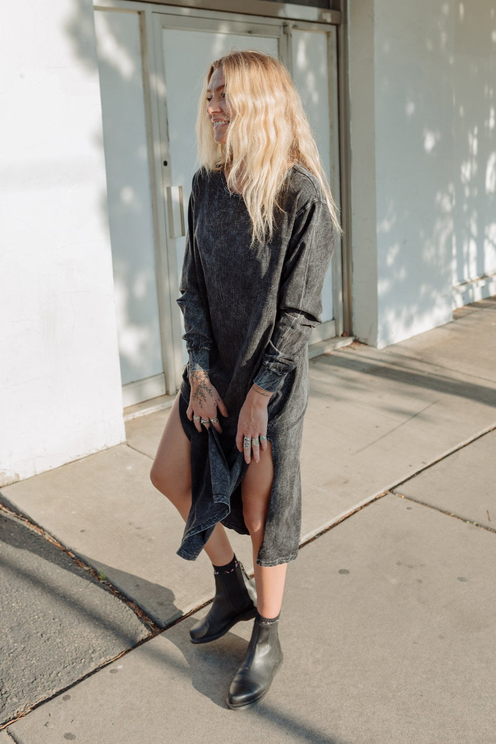 The Taylor Dress in four colors: Brown, Denim, Washed Black, and Peach, featuring long sleeves, a crew neck, and a slight hem slit.