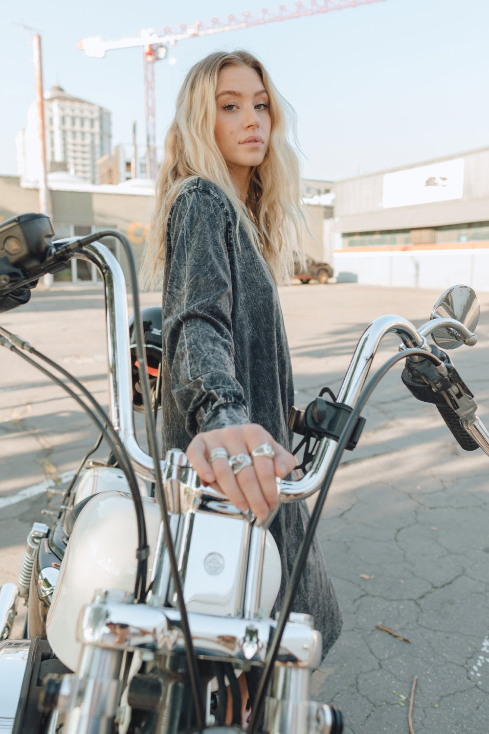 The Taylor Dress in four colors: Brown, Denim, Washed Black, and Peach, featuring long sleeves, a crew neck, and a slight hem slit.