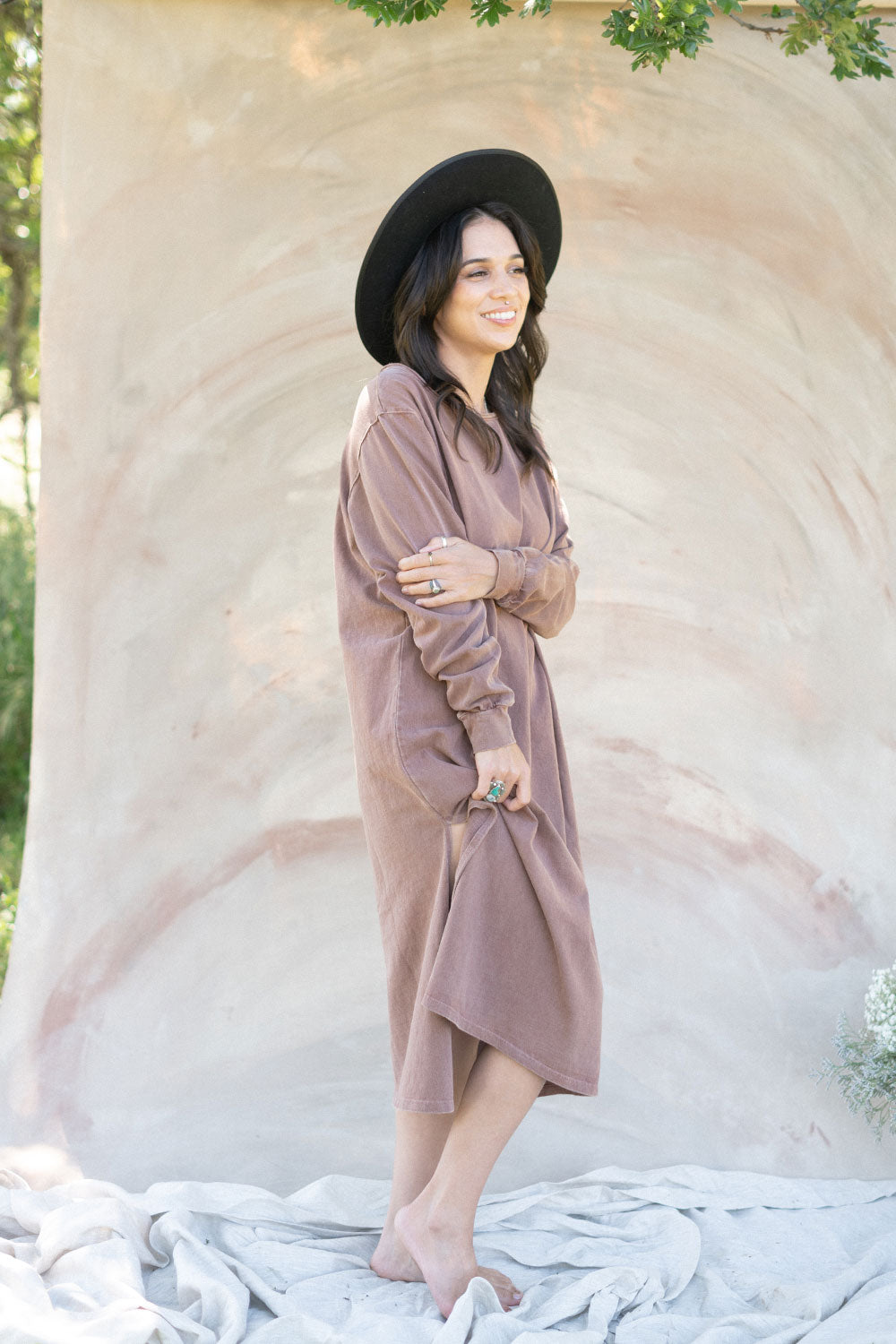 The Taylor Dress in four colors: Brown, Denim, Washed Black, and Peach, featuring long sleeves, a crew neck, and a slight hem slit.